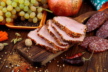 
red meat beef with fruit grape pomegranate on a cutting board with spices