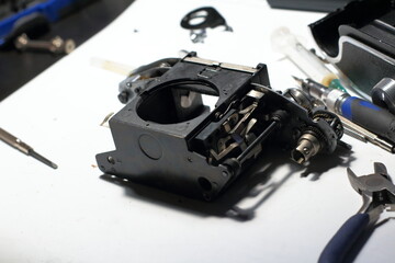 Disassembled vintage camera on a white table. Repair an old analog film camera. Selective focus.