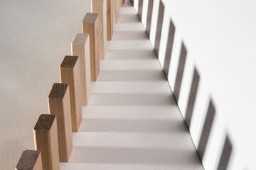 Fototapeta premium Wooden blocks in a row. Geometric shapes from light and shadow. Illusion, concept.