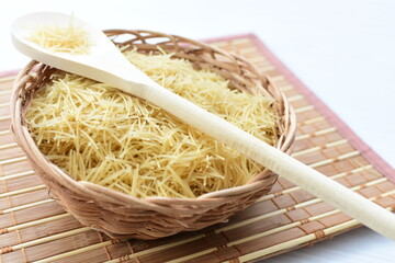 Short pasta spaghetti angel hair displayed in containers on white background