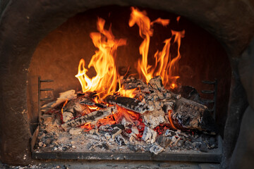 Wood burning in empty barbecue grill, outdoor fireplace grill