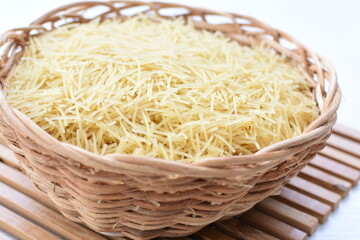 Short pasta spaghetti angel hair displayed in containers on white background