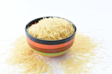 Short pasta spaghetti angel hair displayed in containers on white background