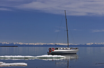 Boat in water with ice  and blue sky