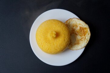 Top view of Brazilian Couscous and fried egg (Cuscuz Brasileiro). Traditional dish from the Northeast region of Brazil.
