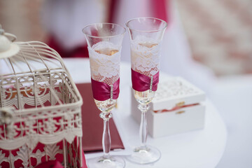 Beautiful decorated holiday glasses with champagne close-up. Holiday glasses