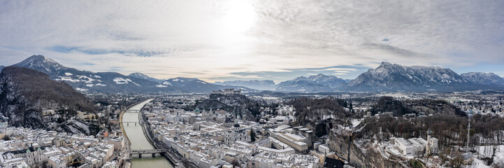 Fototapeta na wymiar Panoramic aerial drone shot view of snoy Salzburg in winter morning