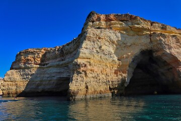Fototapeta premium Benagil cave from the sea side. Beautiful natural sea cave with blue sky and atlantic ocean in Carvoeiro.