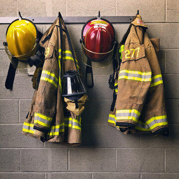 Firefighter Helmet And Protection Coat Hanging In The Fire Station