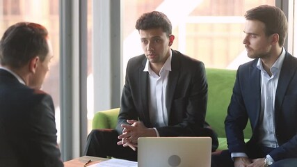 Middle eastern ethnicity businessman take part in negotiations with business partner, representative and client disuses contract terms and conditions future common cooperation sit on couch in office