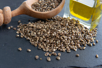 Hemp seeds heap nearby wooden spoon