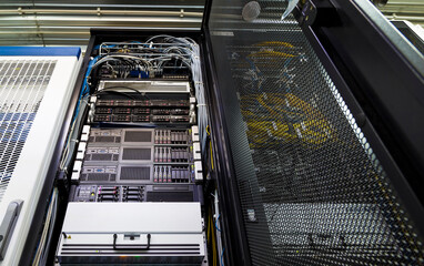 Bottom view of rack server against neon light in datacenter with dept of field