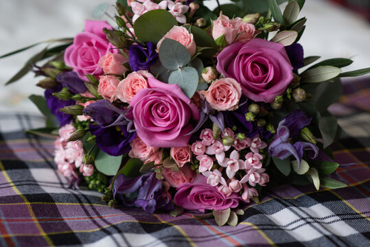 pink bouquet of flowers on tartan