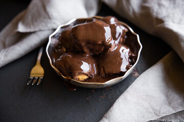 Delicious eclairs with cream and chocolate frosting on a plate