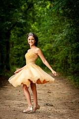 Fototapeta na wymiar Teenager smiling brazilian girl swinging her princess dress in the park.
