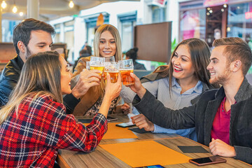 Young happy friends drinking beer - Friendship and celebration concept 