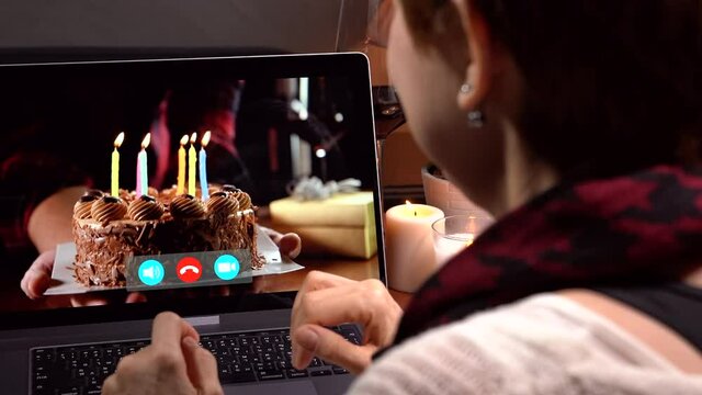 Asian middle aged woman feeling loved and happy while celebrating virtual birthday via video call at home during social distancing