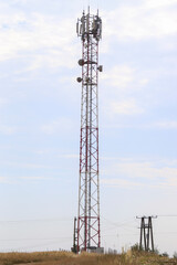 Telecommunication tower with sky and blue clouds. Radio and satellite pole. Communication technology. Transmitter tower. Mobile or telecom tower 4g 5g network.