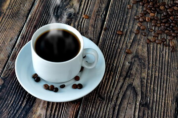 white cup of coffee on a wooden table with scattered grains