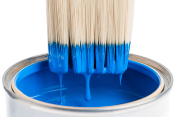 Dripping paint paintbrush and can closeup on white background