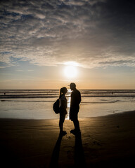 couple in the beach in sunset