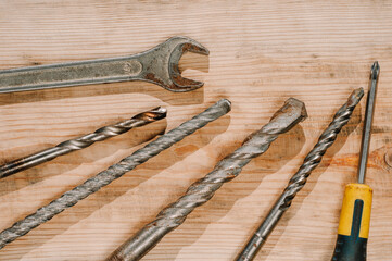 Building tools including centimeter ruler, wrench and cutter placed in the right side on wooden surface with open space. Top view composition. Measurement. Fixing and cropping. Hand tool. Tools for
