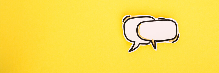 Paper speech bubbles icon on the yellow