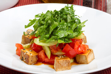Fresh vitamin salad of feta, tomatoes, arugula leaves and sesame seeds. As backdrop for menus, cookbooks, advertisements and other culinary projects