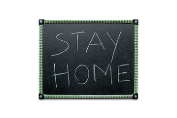 Stay home written on a kid's black slate board isolated on a white background