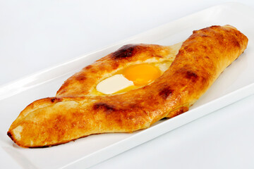 Pita with cheese and eggs. Turkish Pide bread with cheese and egg topping (exclusive to the Black Sea region). As backdrop for menus, cookbooks, advertisements and other culinary projects
