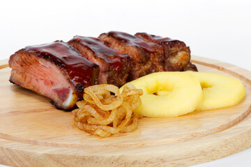 Pork ribs Chelogach with fried onions and slices of fresh apples. For design of menus, cookbooks, advertising products for the restaurant business