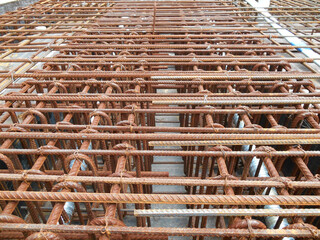 Hot-rolled deformed steel bars or steel reinforcement bar tied together before casting in the concrete. Its function is to increase the concrete strength. 