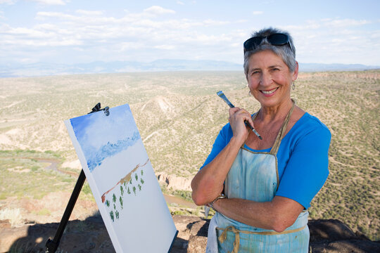 senior woman artist painting landscape, White Rock, New Mexico