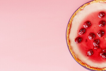 Plain cheesecake with cherry jelly on plate . Closeup view with copy space