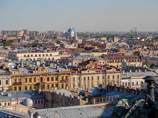 Fototapeta na wymiar Famous roofs of Saint Petersburg on a clear summer day. On the horizon of the dome of the Church.