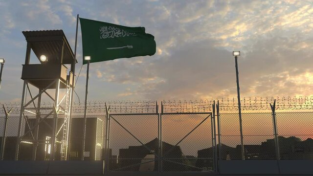 Waving flag of Saudi arabia above military base in the evening