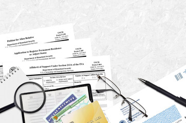 I-130 Petition for alien relative, I-485 Application to register permanent residence or adjust status and I-864 Affidavit of support under section 213A of the INA forms lies on table