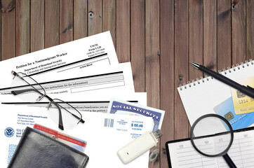 USCIS form I-129 Petition for a nonimmigrant worker lies on flat lay office table and ready to...