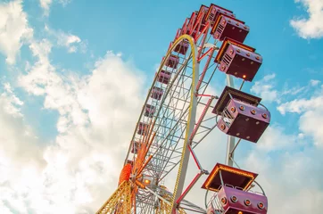 Fotobehang Ferris wheel on a blue sky with clouds © dimazel