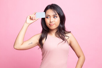 Young Asian woman think with a blank card.