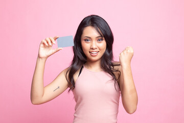 Young Asian woman fist pump with blank card.