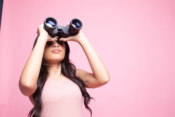 Young Asian woman with binoculars.