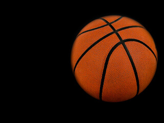 Fototapeta premium Basketball isolated on a black background as a sports and fitness symbol of a team leisure activity