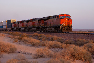 Freight train speeding through the desert with multiple engines 