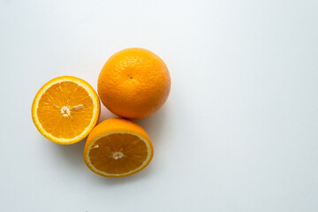 group of orange fruits isolated on a white table. cut orange. view from above
