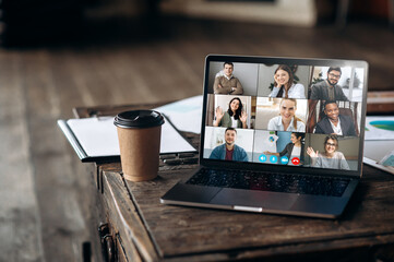 App for remote communication. Virtual meeting online. Video conference by laptop. Online business meeting. On the laptop screen, people who gathered in a video conference to work on-line - obrazy, fototapety, plakaty