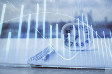 Multi exposure of financial graph drawings and desk with open notebook background. Concept of forex