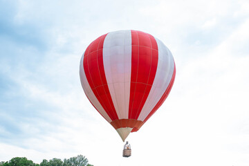 Fototapeta premium Balloon in the blue sky. Red balloon in the blue cloudy sky.