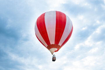Balloon in the blue sky. Red balloon in the blue cloudy sky.