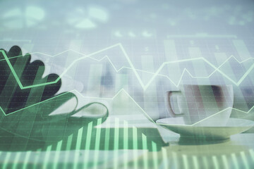 Double exposure of financial chart drawing and desktop with coffee and items on table background. Concept of forex market trading